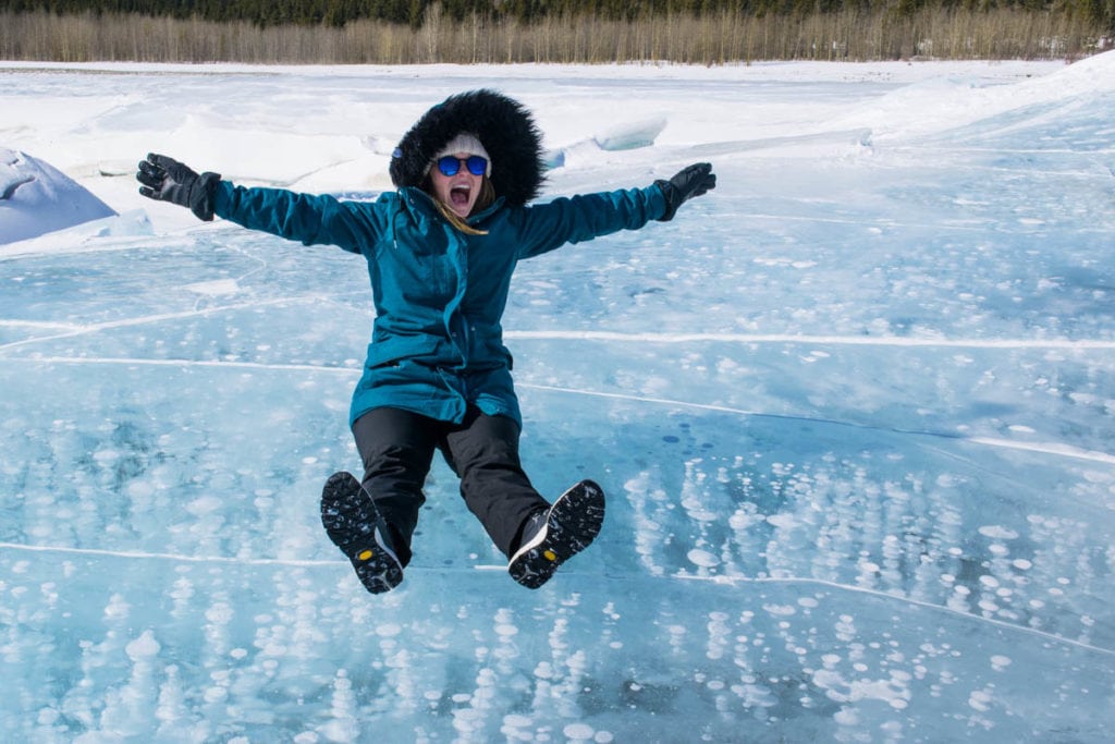 Enjoying the ice bubbles on Abraham Lake, Alberta, Canada