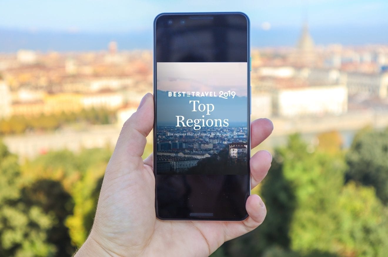 Best In Travel Region on phone with Turin backdrop